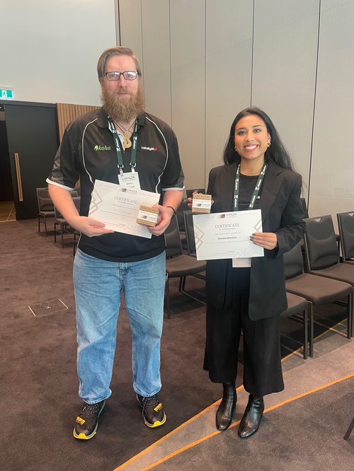 Chris Cormack and Aleisha Amohia holding their speaker certificates and gifts after presenting