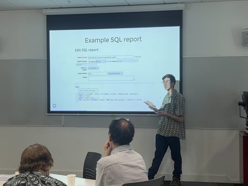 Alex Buckley presenting about the Koha reports module at the AUT-hosted user group in Tāmaki Makaurau Auckland