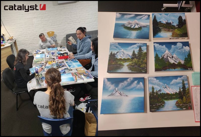 A group of people are sitting around a table painting. Also a close up of their finishing paintings, snowy landscape scenes.